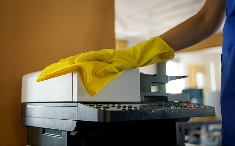 Copier being cleaned and maintained as part of preventive servicing