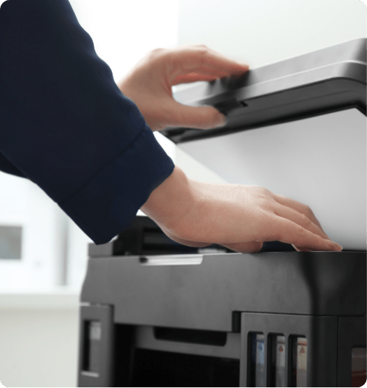 TTS Copier technician preparing a multifunction printer for delivery